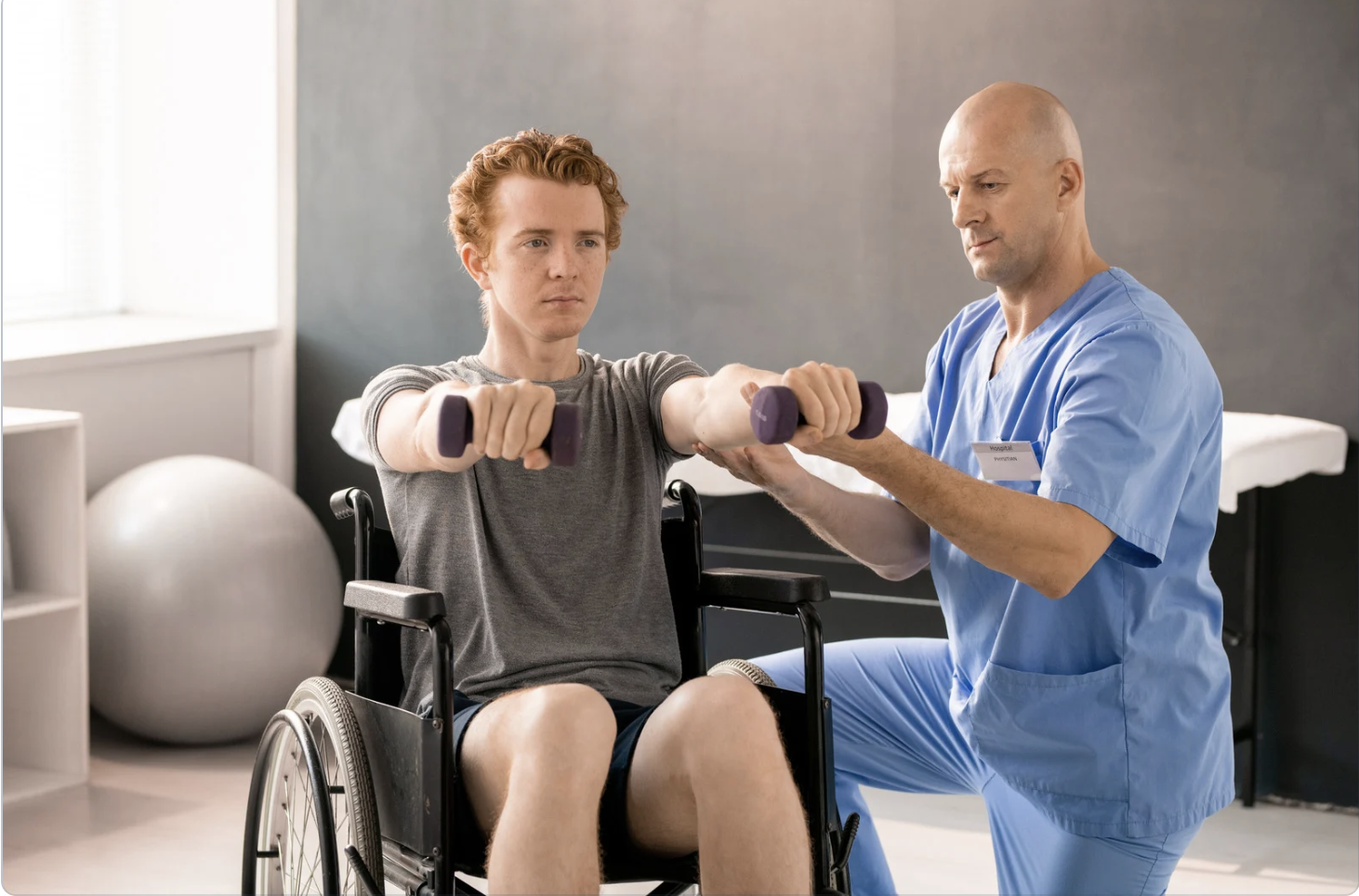 Physical therapist guiding a patient through prescribed movement and therapeutic exercise